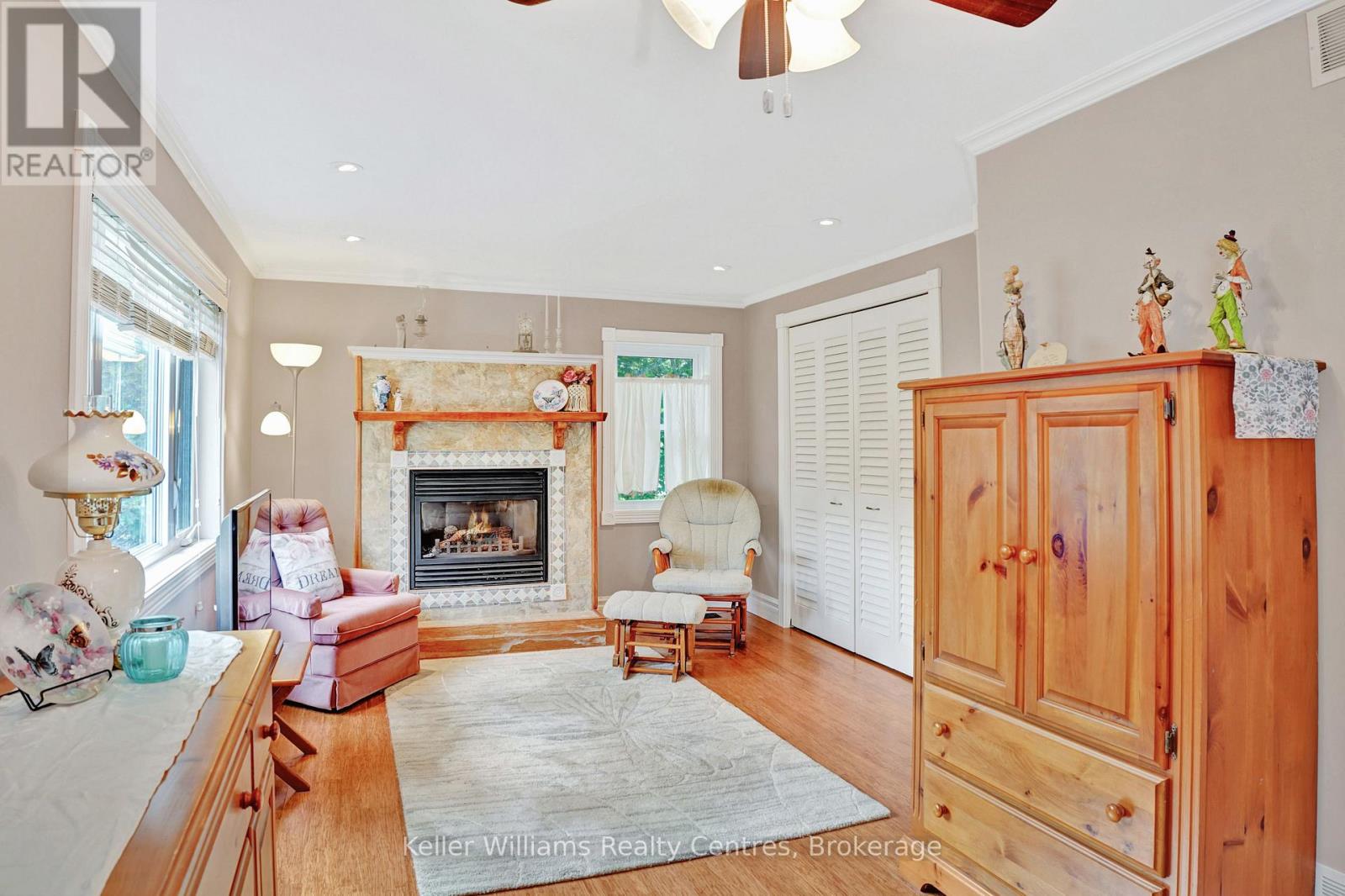 Primary bedroom with a gas fireplace and walls of closets