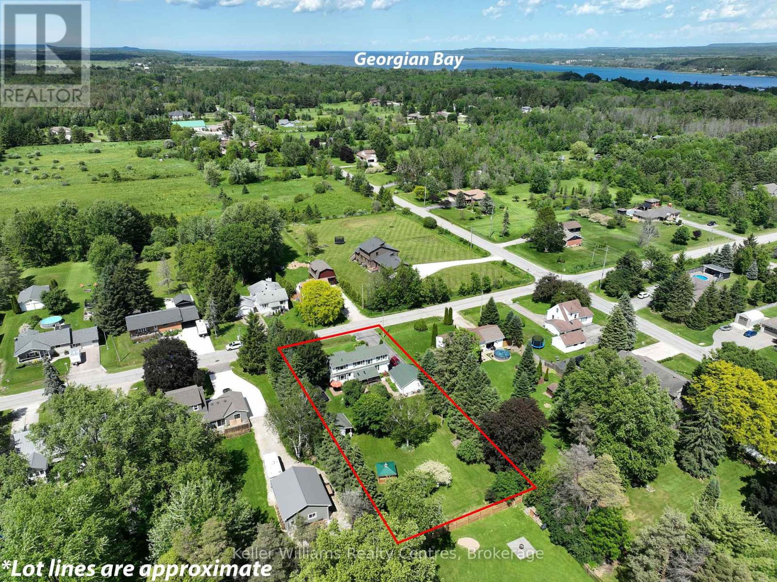 Aerial view of the property with Georgian Bay visible in the distance