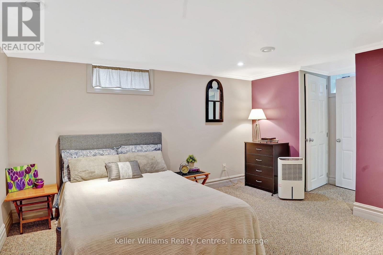 Finished lower-level bedroom with full window and adjoining bath